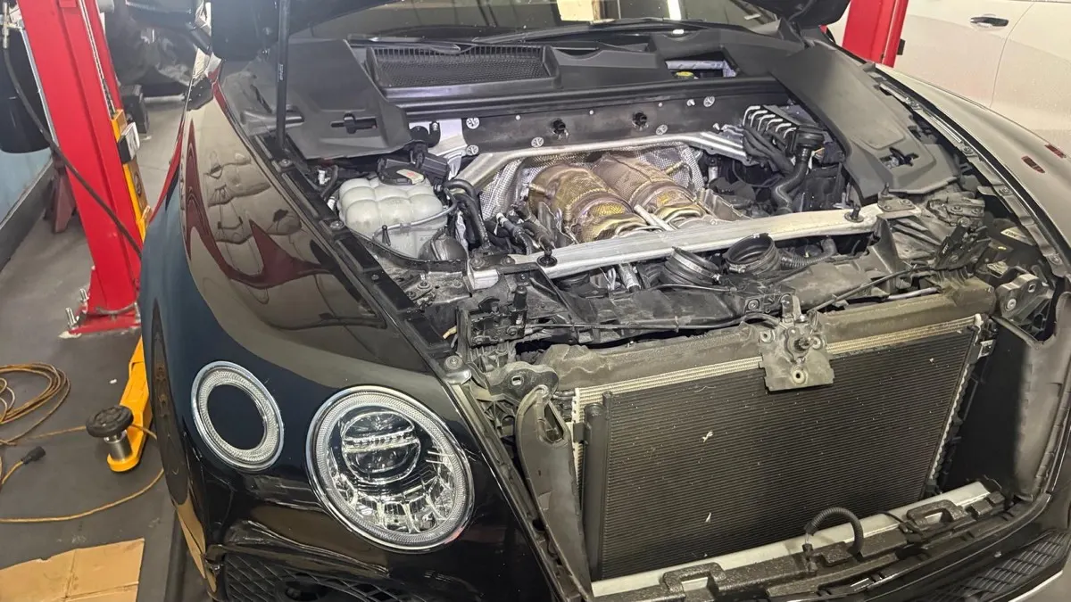 Bentley on the lift with front end removed for repair