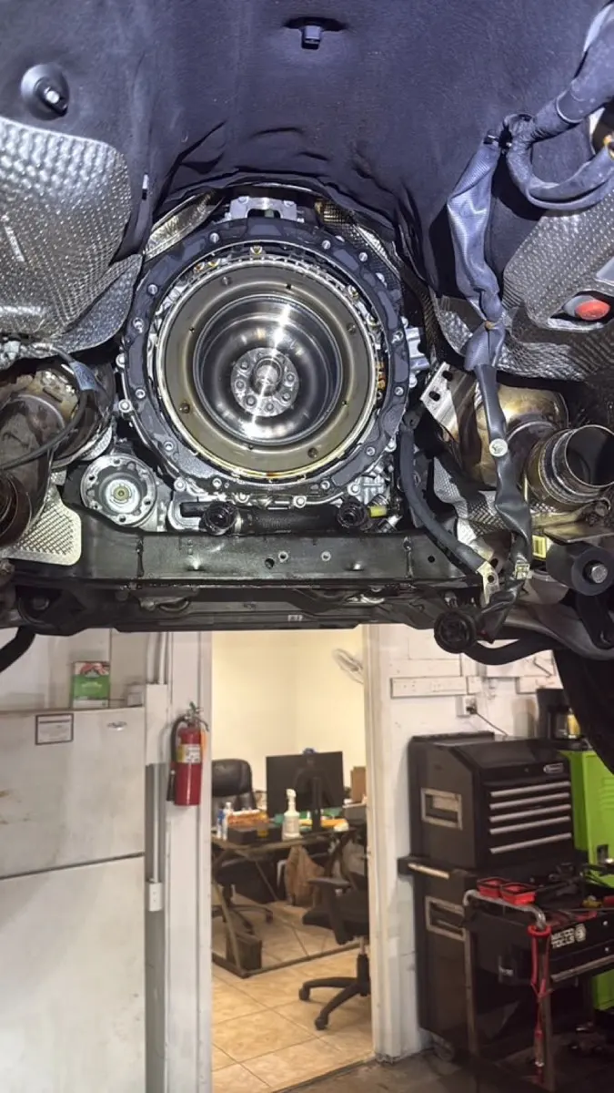 Transmission and flywheel exposed during transmission service